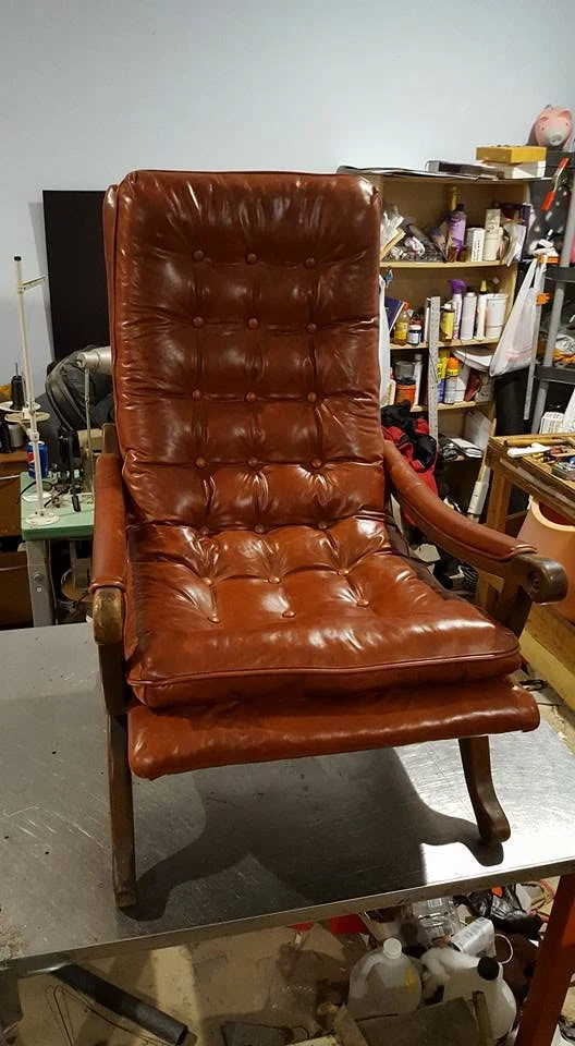 After: the same tufted leather chair finished in rich dark brown